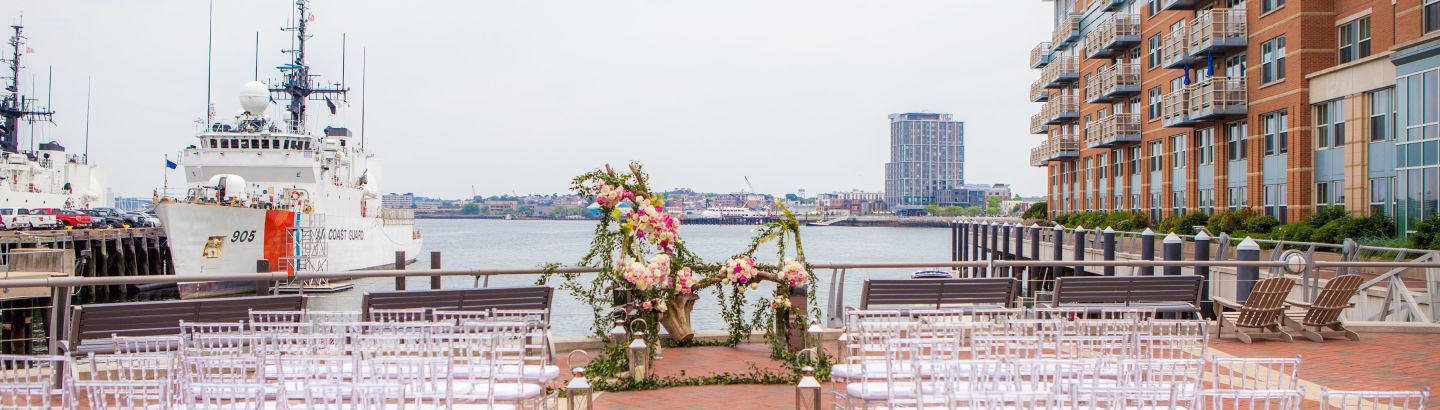 Outdoor wedding venue on Boston Ma waterfront hotel - view of harbor and Coast Guard vessel